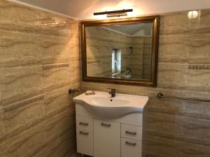 a bathroom with a sink and a mirror at Vila Timona in Eforie Nord +60 photos