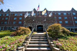 a building with a staircase in front of a building with flags at The Grand Summit Hotel in Summit