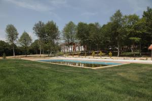 a swimming pool in the middle of a grass field at Yıldız Country Hotel in Sinop