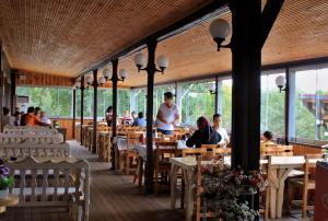 a restaurant with people sitting at tables in a building at Yıldız Country Hotel in Sinop