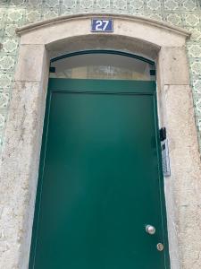a green door with a number above it at SORIANO Place in Lisbon