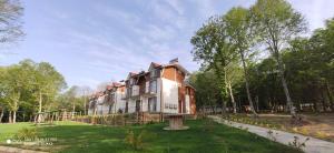 a large house in the middle of a park at Yıldız Country Hotel in Sinop