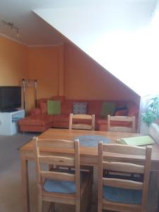 a living room with a table and chairs and a couch at Garden apartments in Znojmo