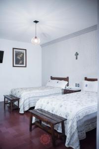 A bed or beds in a room at Hotel Posada del Balsas