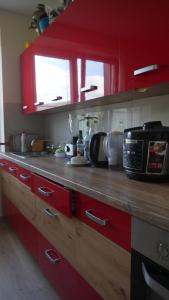 a kitchen with red cabinets and a counter top at Pokoje u TATY in Krościenko