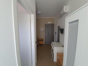 a hallway with a kitchen and a table in a room at Casale Marcalia - bed & breakfast in Corigliano Calabro +32 photos