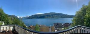 a view of a lake from a balcony at Faleide Panorama by Homes & Villas in Stryn