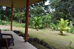 a view of a garden from the porch of a house at Hotel Arenal Country Inn in Fortuna
