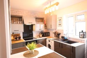 a kitchen with a sink and a counter top at Magdalen Quarters in Exeter