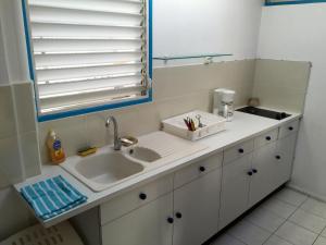 a bathroom with a sink and a mirror at JSG Locations in Sainte-Anne +13 photos
