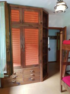 a wooden cabinet with wooden doors in a room at Appartamento Vacanza a Santa Brigida( BG) in Santa Brigida