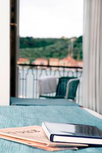 a book sitting on top of a bed at Hotel Della Baia in Portovenere