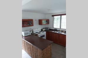 a kitchen with white appliances and a counter top at The Calm House in Turrialba