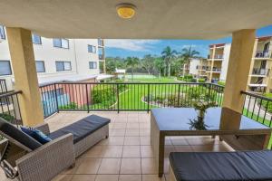 a balcony with patio furniture and a view of a park at By The Beach Relaxs - 3 Beds 2 Bath-Pool-Tennis-Golf in Marcoola