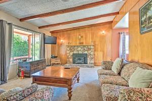 a living room with a couch and a coffee table at Scenic Kernville Home - Walk to Downtown and River! in Kernville