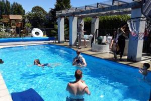 a group of people swimming in a swimming pool at Maples on Harewood in Christchurch