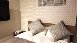 Postel nebo postele na pokoji v ubytování Hotel Sun Royal Utsunomiya