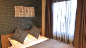 Postel nebo postele na pokoji v ubytování Hotel Sun Royal Utsunomiya