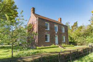 an old brick house with a fence in front of it at Hill House Farm by Bloom Stays in Canterbury