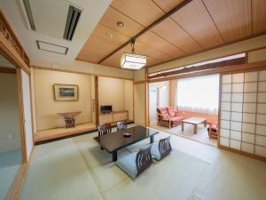 a living room with a table and a couch at Kawayu Kanko Hotel in Teshikaga
