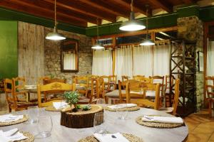 un comedor con mesas, sillas y luces en Valle de Aísa, en Aísa
