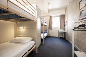 a bedroom with a bed and a desk at Melbourne Metro YHA in Melbourne