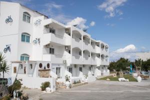 a white apartment building with a lot of windows at Lisabeth Apartments in Faliraki