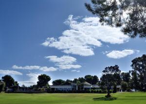 a park with a blue sky and clouds at Renmark Country Club in Renmark