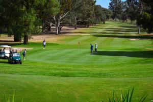 un grupo de personas jugando al golf en un campo de golf en Renmark Country Club, en Renmark