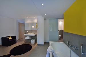 une grande salle de bain avec une baignoire et un lavabo dans l'établissement Cottage 1956 - Maison d'hôtes, à Trois-Épis 30 autres photos