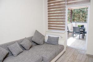 a couch sitting in a living room with a table at Villa Verdaine in Šilutė