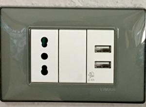 an electrical socket with a light switch on it at Agriturismo Orione in Marina di Campo