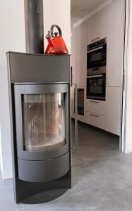 a kitchen with a stove with a red kettle on top at Antica Sosta dei Viandanti in Cadenazzo