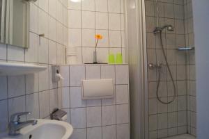 a bathroom with a shower, sink, and toilet at Grand Hostel Berlin Classic in Berlin
