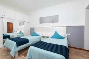 2 camas en una habitación con almohadas azules en Sa Llimonera, en Sant Llorenç des Cardassar