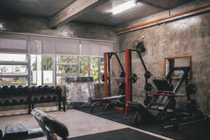 a room with a gym with a treadmill and weights at Dungun Escapade Resort in Dungun