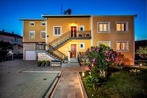 a large house with a staircase in front of it at Apartments Euphemia in Rovinj
