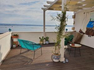 a patio with chairs and plants on a deck at B&B La Terrazza di NonnAnna in Taranto