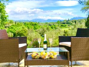 a table with two glasses and a bottle of wine at Armonia Corfu Luxury Apartment in Corfu Town