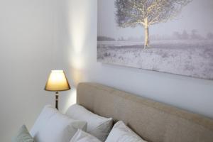 a bedroom with a couch and a picture of a tree at Areti InCreteble Cretan Residences Collection in Sitia