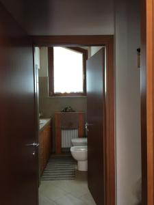 a bathroom with a toilet and a window at La vista sulla Valmalenco in Lanzada +22 photos
