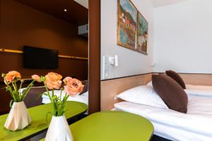 Postel nebo postele na pokoji v ubytování Art Hotel Pallas by Tartuhotels