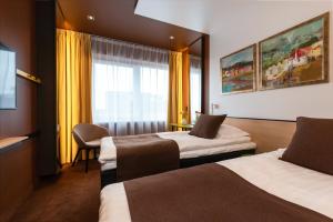 Postel nebo postele na pokoji v ubytování Art Hotel Pallas by Tartuhotels