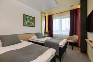 Postel nebo postele na pokoji v ubytování Art Hotel Pallas by Tartuhotels