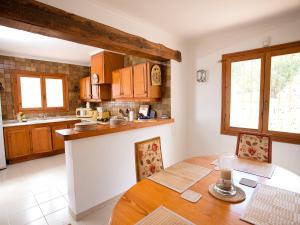 a kitchen with a wooden table and a counter top at Holiday Home Amarilla by Interhome in Pedramala