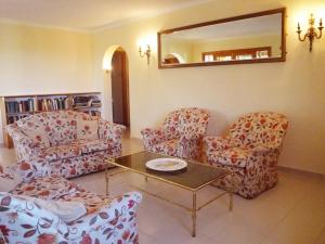 a living room with two chairs and a table at Holiday Home Amarilla by Interhome in Pedramala