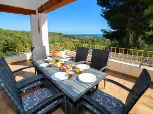 a table and chairs on a patio with a view of the ocean at Holiday Home Amarilla by Interhome in Pedramala