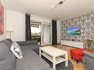 a living room with a couch and a table at Apartments Špadići in Poreč
