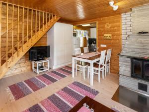eine Küche und ein Esszimmer mit einem Tisch und einer Treppe in der Unterkunft Holiday Home Pinea by Interhome in Niittymaa