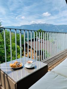 a table with two plates of food on a balcony at Ferienwohnung Konzept Schmiede in Seeboden